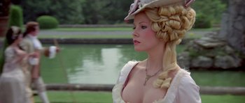 Movie still from “History of the World: Part I” (1981), directed by Mel Brooks – A woman in a white dress and a hat; Close Up shot, Over the shoulder angle