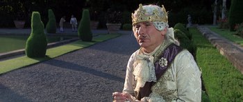 Movie still from “History of the World: Part I” (1981), directed by Mel Brooks – An old man dressed as a king in a garden; Close Up shot, Low angle