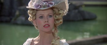 Movie still from “History of the World: Part I” (1981), directed by Mel Brooks – A woman in a white dress and a pink hat; Close Up shot, Over the shoulder angle