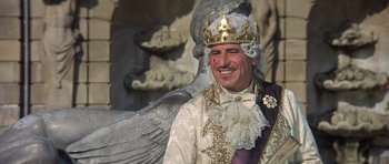 Movie still from “History of the World: Part I” (1981), directed by Mel Brooks – A man wearing a crown and a white robe; Medium shot, Low angle