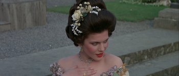 Movie still from “History of the World: Part I” (1981), directed by Mel Brooks – A woman in a dress with flowers in her hair; Close Up shot, Over the shoulder angle