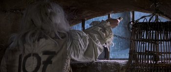 Movie still from “History of the World: Part I” (1981), directed by Mel Brooks – A woman in a white dress is standing on a ledge; Medium shot, Low angle