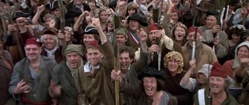 Movie still from “History of the World: Part I” (1981), directed by Mel Brooks – A group of people dressed in medieval clothing; Wide shot, High angle