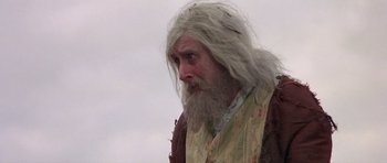 Movie still from “History of the World: Part I” (1981), directed by Mel Brooks – An old man with long white hair and a beard; Close Up shot, Low angle