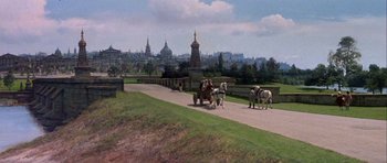 Movie still from “History of the World: Part I” (1981), directed by Mel Brooks – A horse drawn carriage traveling down a road in a park; Extreme Wide shot, High angle