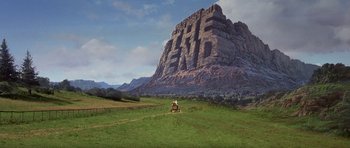 Movie still from “History of the World: Part I” (1981), directed by Mel Brooks – An image of a man riding a horse in front of a mountain; Extreme Wide shot, Low angle