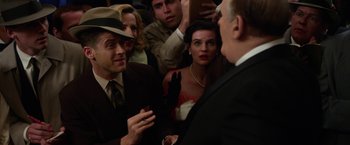 Movie still from “Hitchcock” (2012), directed by Sacha Gervasi – A group of people standing around each other in a room; Medium shot, Over the shoulder angle