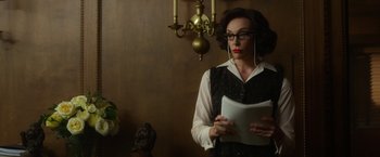 Movie still from “Hitchcock” (2012), directed by Sacha Gervasi – A woman in glasses is holding a book; Medium shot, Low angle