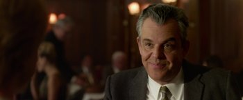 Movie still from “Hitchcock” (2012), directed by Sacha Gervasi – An older man wearing a suit and tie; Close Up shot, Over the shoulder angle