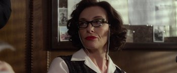 Movie still from “Hitchcock” (2012), directed by Sacha Gervasi – A person wearing glasses; Close Up shot, Over the shoulder angle