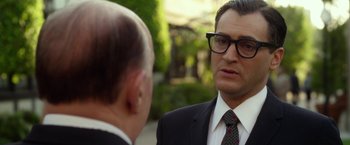 Movie still from “Hitchcock” (2012), directed by Sacha Gervasi – A man in a suit and tie talking to another man; Close Up shot, Over the shoulder angle