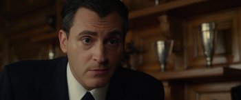 Movie still from “Hitchcock” (2012), directed by Sacha Gervasi – A person wearing a suit and tie; Close Up shot, Over the shoulder angle