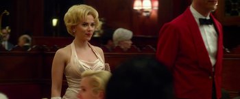Movie still from “Hitchcock” (2012), directed by Sacha Gervasi – A woman with blonde hair wearing a white dress; Medium shot, Over the shoulder angle