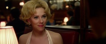 Movie still from “Hitchcock” (2012), directed by Sacha Gervasi – A woman sitting in a booth at a restaurant; Close Up shot, Over the shoulder angle