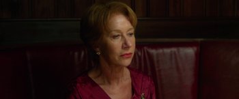 Movie still from “Hitchcock” (2012), directed by Sacha Gervasi – An older woman sitting on a couch looking off to the side; Close Up shot, Low angle
