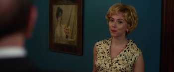 Movie still from “Hitchcock” (2012), directed by Sacha Gervasi – A woman standing in front of a painting of a woman; Medium shot, Over the shoulder angle