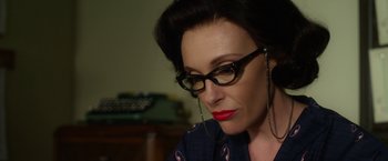 Movie still from “Hitchcock” (2012), directed by Sacha Gervasi – A person wearing glasses; Close Up shot, Over the shoulder angle