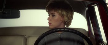 Movie still from “Hitchcock” (2012), directed by Sacha Gervasi – A woman sitting behind the steering wheel of a car; Close Up shot, Over the shoulder angle