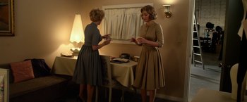 Movie still from “Hitchcock” (2012), directed by Sacha Gervasi – Two women are standing next to each other in front of a mirror; Medium shot, Over the shoulder angle