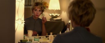 Movie still from “Hitchcock” (2012), directed by Sacha Gervasi – A woman sitting in front of a mirror looking at herself in the mirror; Medium shot, Over the shoulder angle