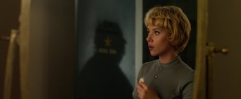 Movie still from “Hitchcock” (2012), directed by Sacha Gervasi – A woman with blonde curly hair holding a toothbrush; Medium shot, Over the shoulder angle