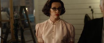 Movie still from “Hitchcock” (2012), directed by Sacha Gervasi – A woman in a polka dot shirt wearing glasses; Close Up shot, Over the shoulder angle