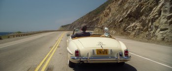 Movie still from “Hitchcock” (2012), directed by Sacha Gervasi – A man and a woman riding in the back of a car; Wide shot, High angle