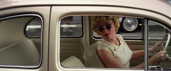 Movie still from “Hitchcock” (2012), directed by Sacha Gervasi – A woman sitting in the back seat of a car looking in the mirror; Medium shot, Over the shoulder angle