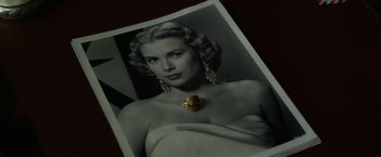 Movie still from “Hitchcock” (2012), directed by Sacha Gervasi – A black and white photo of a woman wearing a necklace; Extreme Close Up shot, High angle