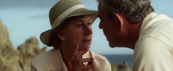 Movie still from “Hitchcock” (2012), directed by Sacha Gervasi – An older woman wearing a hat and a man with his hand on her face; Close Up shot, Over the shoulder angle