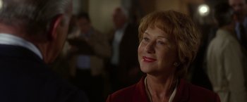 Movie still from “Hitchcock” (2012), directed by Sacha Gervasi – An older woman is smiling for the camera; Close Up shot, Over the shoulder angle