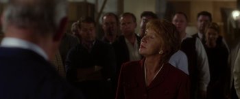 Movie still from “Hitchcock” (2012), directed by Sacha Gervasi – A group of people standing in a dark room; Close Up shot, Over the shoulder angle