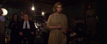 Movie still from “Hitchcock” (2012), directed by Sacha Gervasi – A woman standing in front of a camera in a room; Medium shot, Over the shoulder angle