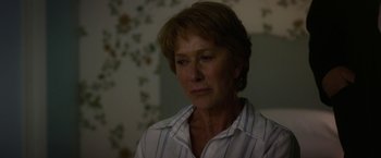 Movie still from “Hitchcock” (2012), directed by Sacha Gervasi – An older woman with short hair wearing a striped shirt; Close Up shot, Over the shoulder angle