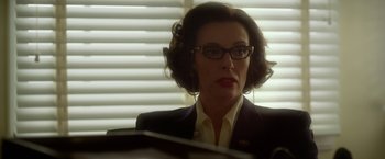 Movie still from “Hitchcock” (2012), directed by Sacha Gervasi – A woman in glasses and a suit looking at a mirror; Close Up shot, Low angle