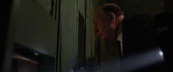 Movie still from “Hitchcock” (2012), directed by Sacha Gervasi – An older man looking into a mirror in a dark room; Close Up shot, Low angle