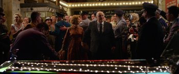 Movie still from “Hitchcock” (2012), directed by Sacha Gervasi – A man and a woman standing next to each other in front of a crowd of onlookers; Wide shot, Over the shoulder angle