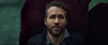 Movie still from “Hitman's Wife's Bodyguard” (2021), directed by Patrick Hughes – A person with a beard; Close Up shot, High angle
