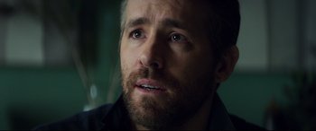 Movie still from “Hitman's Wife's Bodyguard” (2021), directed by Patrick Hughes – A person with a beard; Close Up shot, Over the shoulder angle