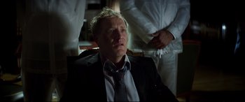 Movie still from “Hitman's Wife's Bodyguard” (2021), directed by Patrick Hughes – A person wearing a suit and tie; Medium shot, Low angle