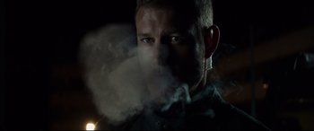 Movie still from “Hitman's Wife's Bodyguard” (2021), directed by Patrick Hughes – A person with smoke coming out of their mouth; Close Up shot, Low angle