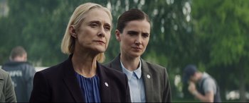 Movie still from “Hitman's Wife's Bodyguard” (2021), directed by Patrick Hughes – Two women standing next to each other in front of trees; Close Up shot, Low angle