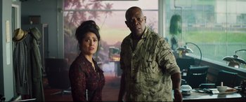 Movie still from “Hitman's Wife's Bodyguard” (2021), directed by Patrick Hughes – A man and a woman standing next to each other; Medium shot, Low angle