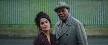 Movie still from “Hitman's Wife's Bodyguard” (2021), directed by Patrick Hughes – A man and a woman standing next to each other; Close Up shot, Low angle