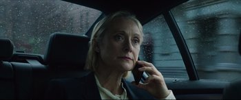 Movie still from “Hitman's Wife's Bodyguard” (2021), directed by Patrick Hughes – A woman sitting in the back of a car talking on a cell phone; Close Up shot, Low angle
