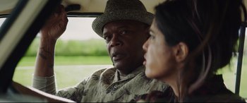 Movie still from “Hitman's Wife's Bodyguard” (2021), directed by Patrick Hughes – A man and a woman sitting in a car looking out the window; Close Up shot, Over the shoulder angle