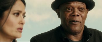 Movie still from “Hitman's Wife's Bodyguard” (2021), directed by Patrick Hughes – A person wearing a hat; Close Up shot, Low angle