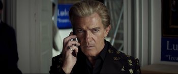 Movie still from “Hitman's Wife's Bodyguard” (2021), directed by Patrick Hughes – A person talking on a cell phone; Close Up shot, Low angle