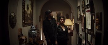 Movie still from “Hitman's Wife's Bodyguard” (2021), directed by Patrick Hughes – A man and a woman are standing in a room together; Medium shot, Low angle