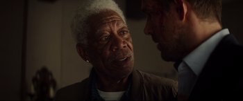 Movie still from “Hitman's Wife's Bodyguard” (2021), directed by Patrick Hughes – An older man talking to a younger man; Close Up shot, Over the shoulder angle